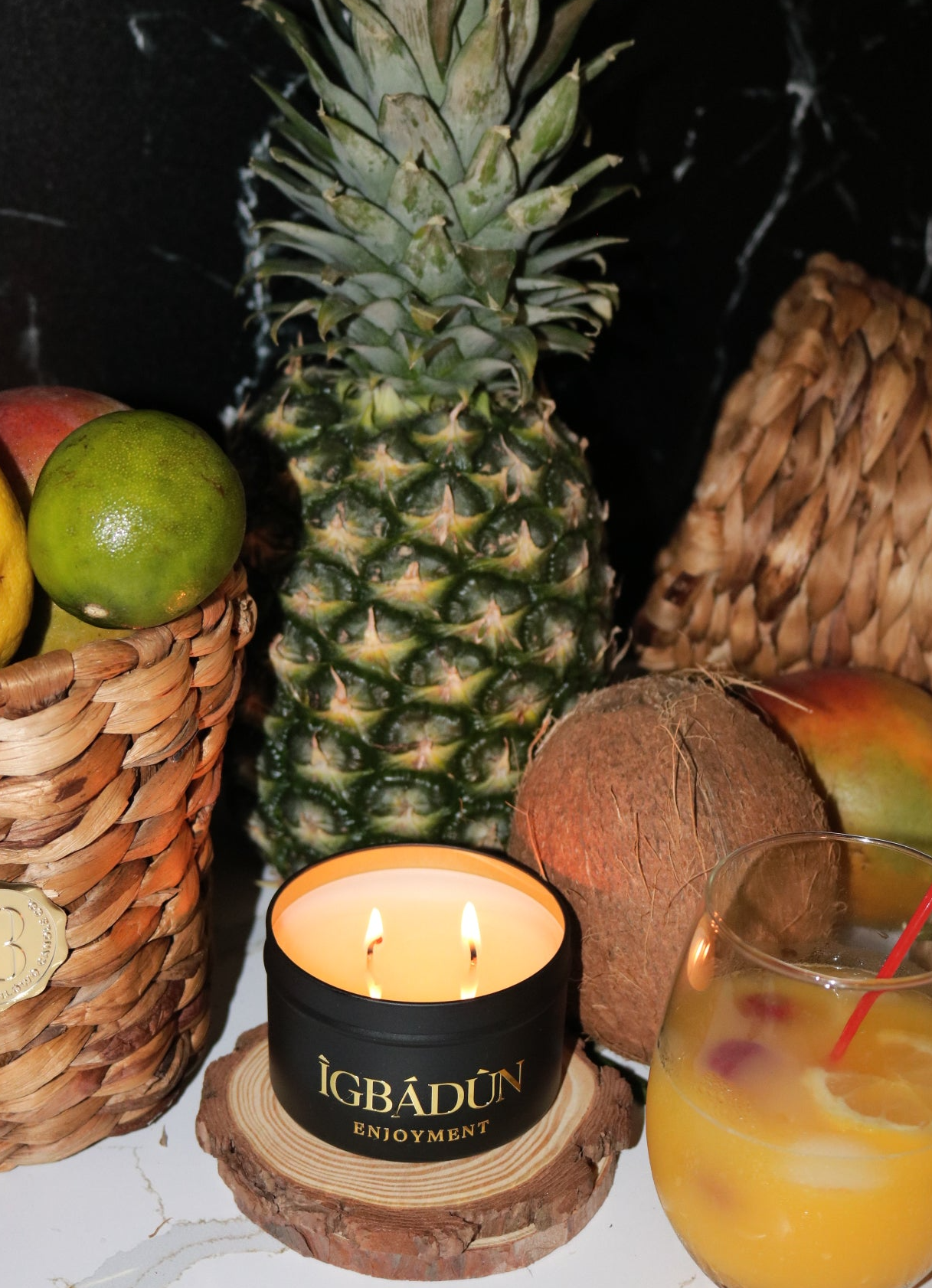 Hand poured black metal candle container with a gold metal logo label, featuring multiple organic wicks, burning with a warm glow. The candle is made with natural coconut and soy wax and non toxic fragrance oils. Decorative candle for aesthetic appeal