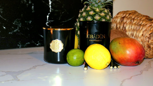 Hand poured black candle container with a gold metal logo label, featuring multiple organic wicks, burning with a warm glow. The candle is made with natural coconut and soy wax and non toxic fragrance oils. Decorative candle for aesthetic appeal