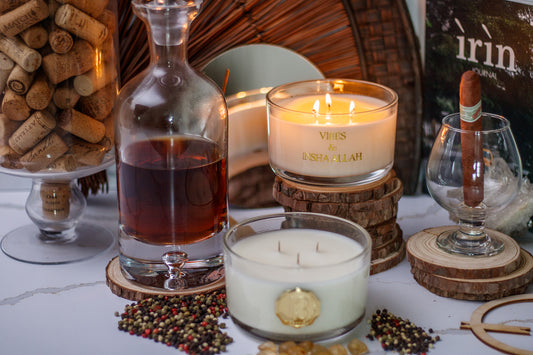 Hand poured clear candle container with a gold metal logo label, featuring multiple organic wicks, burning with a warm glow. The candle is made with natural coconut and soy wax and non toxic fragrance oils. Decorative candle for aesthetic appeal